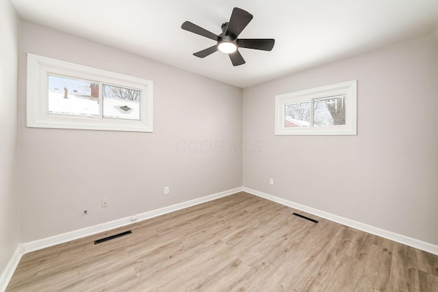 spare room featuring ceiling fan and light hardwood / wood-style floors