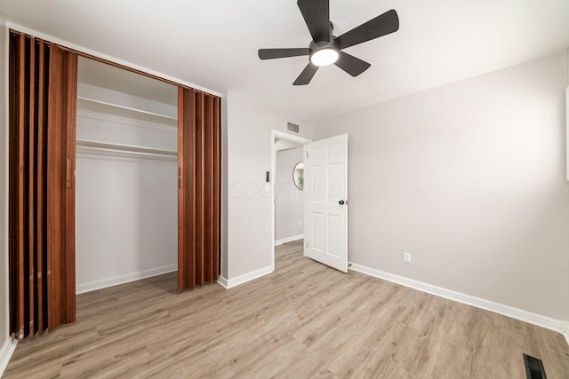 unfurnished bedroom with a closet, ceiling fan, and light wood-type flooring