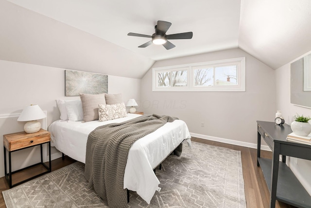 bedroom with vaulted ceiling, ceiling fan, and hardwood / wood-style flooring