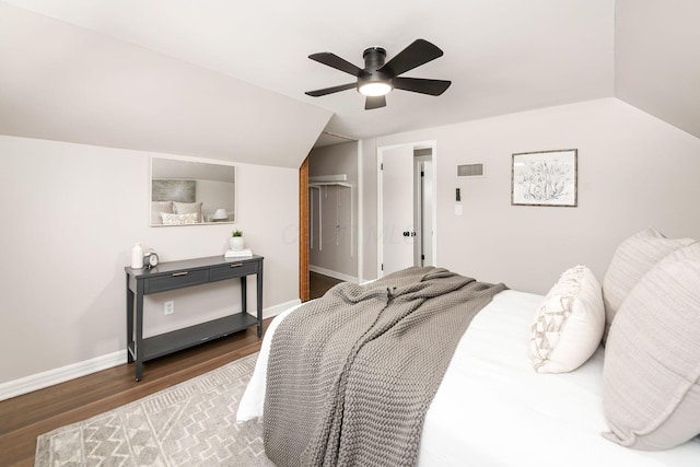 bedroom with ceiling fan, dark hardwood / wood-style flooring, and lofted ceiling