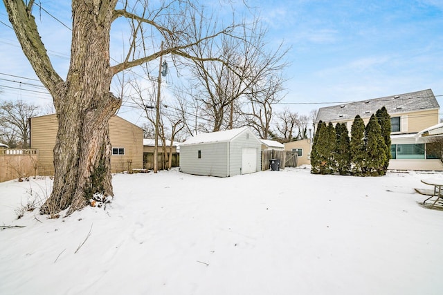 yard covered in snow with a storage unit