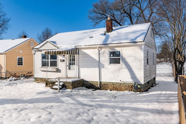 view of snow covered back of property