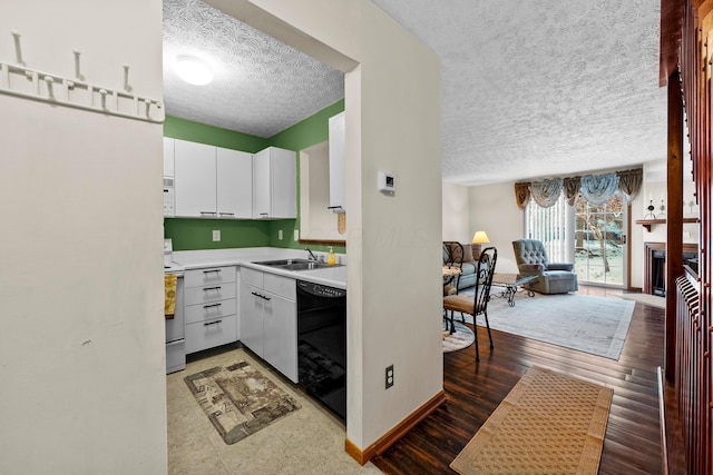 kitchen featuring electric stove, dishwasher, dark hardwood / wood-style flooring, white cabinets, and sink