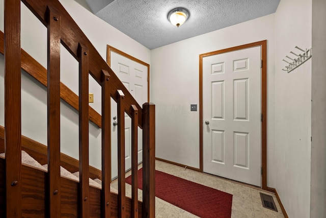 entryway with a textured ceiling