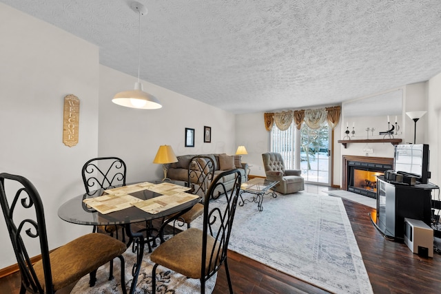 dining room featuring a textured ceiling and dark hardwood / wood-style floors