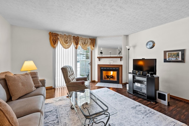 living room featuring a fireplace, a textured ceiling, and dark hardwood / wood-style floors