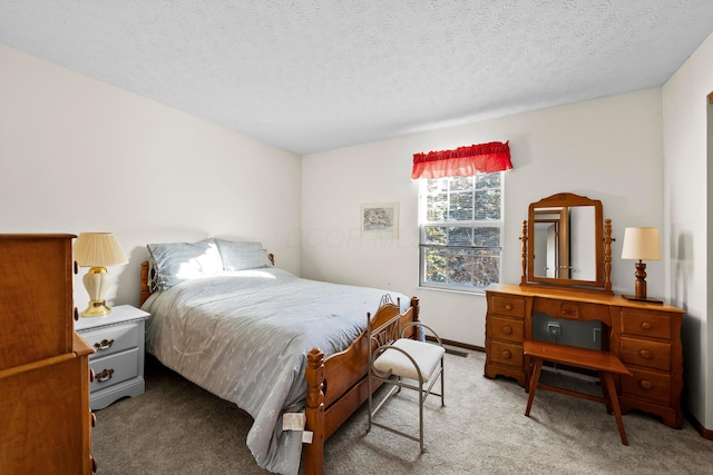 bedroom with a textured ceiling and carpet