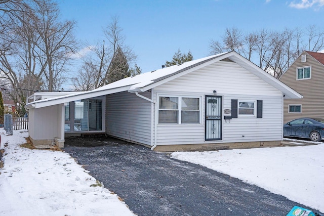 view of front of property featuring a carport