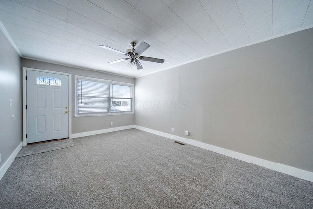 interior space with ceiling fan and crown molding