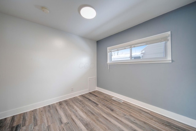 spare room featuring wood-type flooring