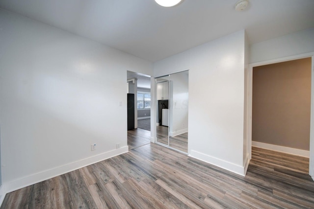 empty room with hardwood / wood-style floors