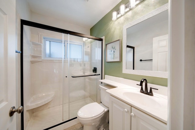 bathroom with an enclosed shower, vanity, and toilet