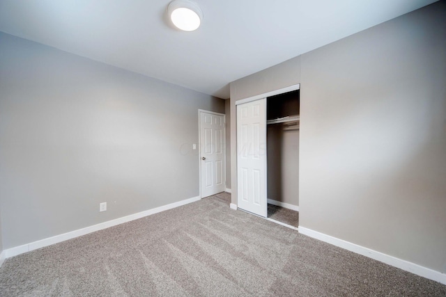 unfurnished bedroom featuring a closet and carpet flooring