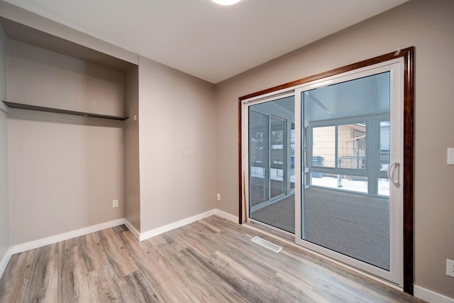 unfurnished bedroom with a closet and light hardwood / wood-style floors