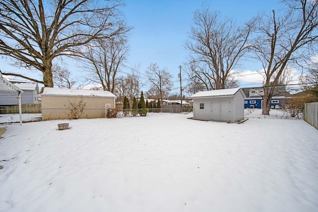 snowy yard with a storage unit