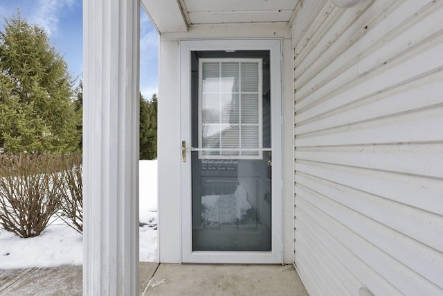 view of snow covered property entrance