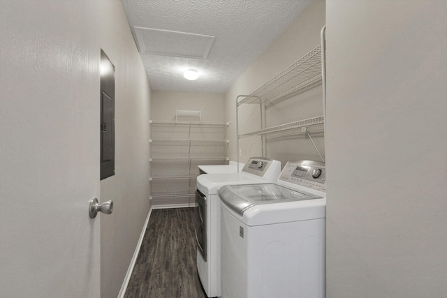 clothes washing area with a textured ceiling, separate washer and dryer, and dark hardwood / wood-style floors