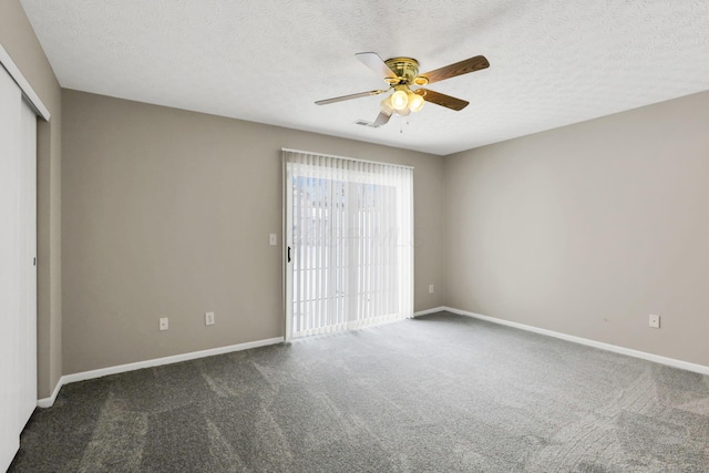 carpeted empty room featuring ceiling fan and a textured ceiling