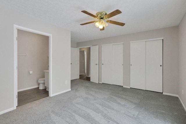 unfurnished bedroom with a textured ceiling, ceiling fan, connected bathroom, and light colored carpet