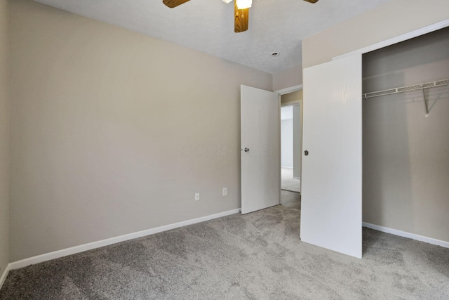 unfurnished bedroom featuring ceiling fan, light colored carpet, and a closet