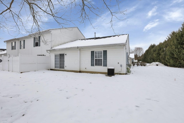 view of snow covered back of property