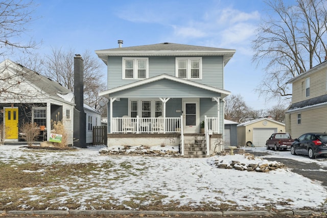 traditional style home with an outbuilding, covered porch, and a garage