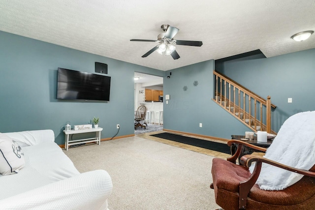 living room with a textured ceiling and ceiling fan