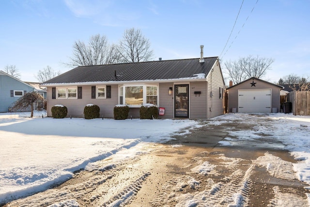 view of front of home with a garage and an outdoor structure