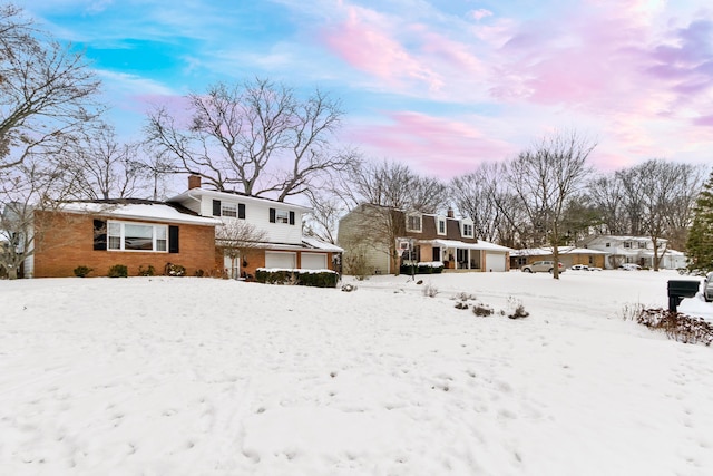 yard layered in snow featuring a garage