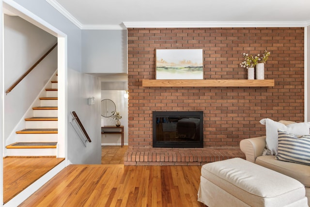 unfurnished living room with wood-type flooring, a fireplace, and crown molding