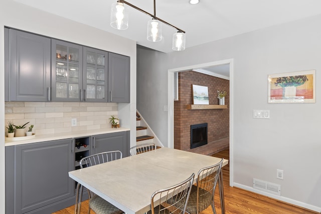 dining space featuring light hardwood / wood-style flooring and a fireplace