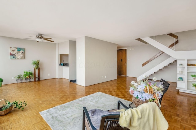 living room with ceiling fan and parquet floors