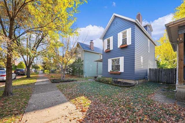 view of side of property with a lawn