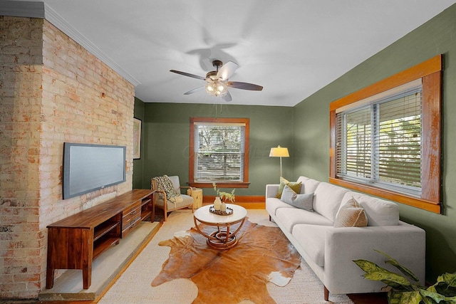 living room featuring ceiling fan and ornamental molding