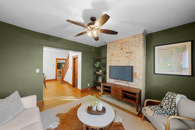 living room featuring ceiling fan and light wood-type flooring