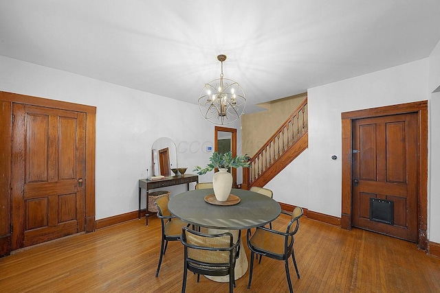 dining room featuring hardwood / wood-style flooring and a chandelier