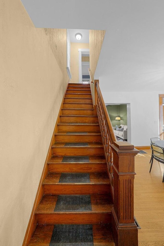 stairway with hardwood / wood-style flooring