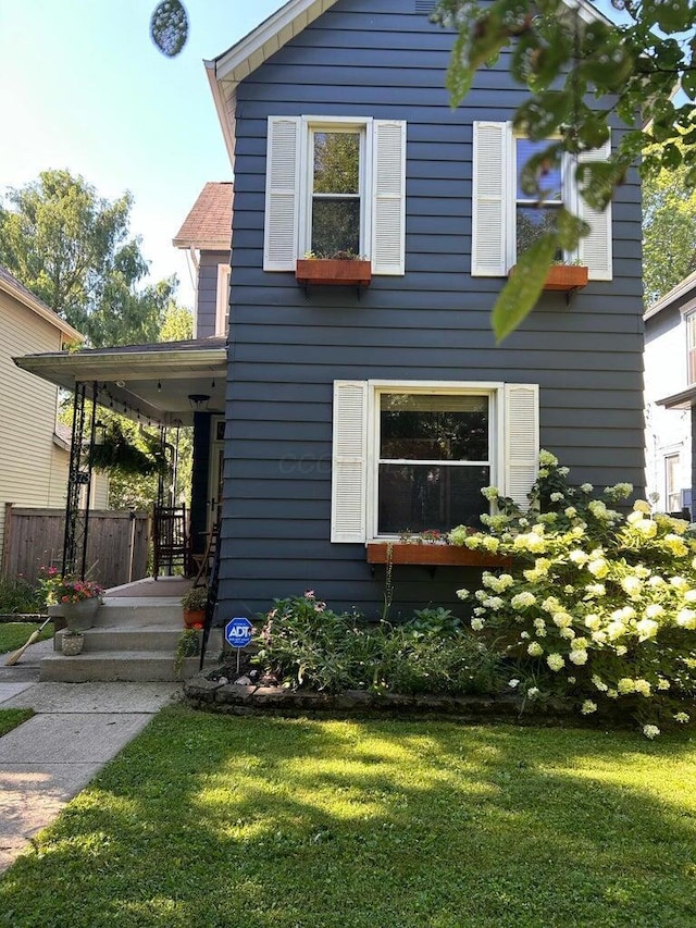 view of side of home with a yard