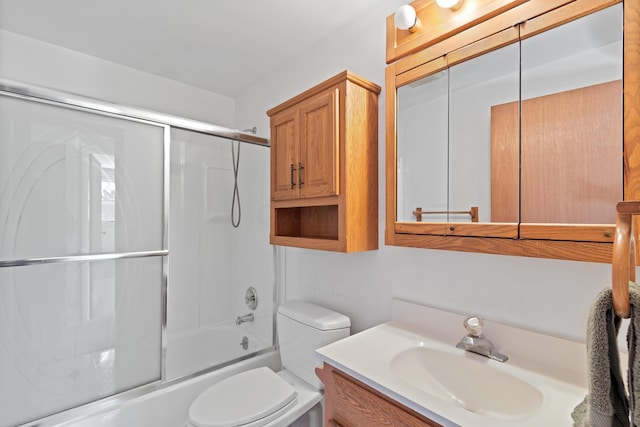 full bathroom with toilet, bath / shower combo with glass door, and vanity