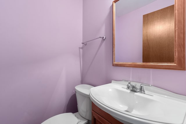 bathroom with toilet and vanity