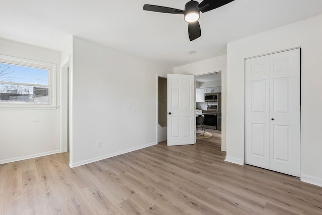 unfurnished bedroom featuring light hardwood / wood-style floors, a closet, and ceiling fan