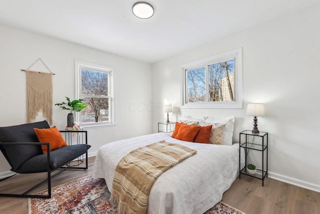 bedroom with hardwood / wood-style flooring