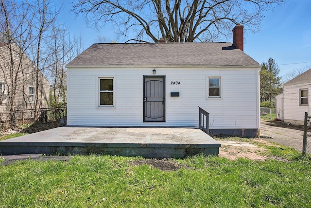 2404 Bancroft St, Columbus, OH 43211 - rear view of property with a shingled roof, a chimney, a wooden deck, and fence