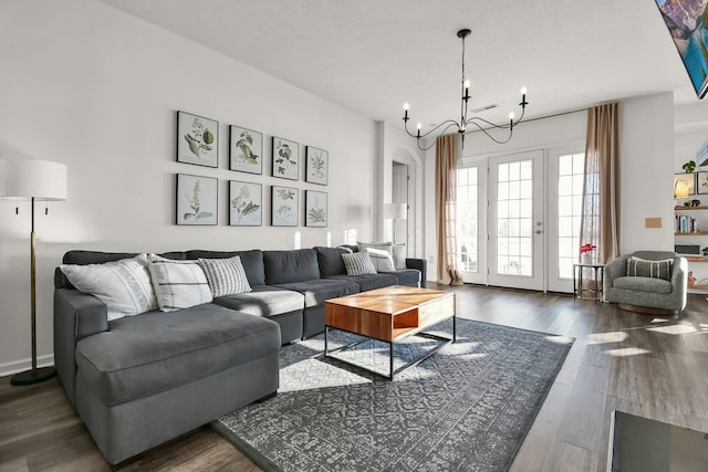 living room featuring an inviting chandelier and dark hardwood / wood-style floors