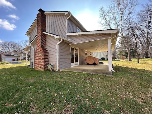 rear view of house with a patio area and a yard