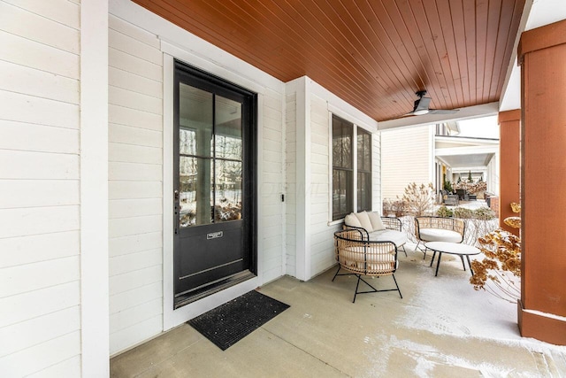 snow covered property entrance with covered porch