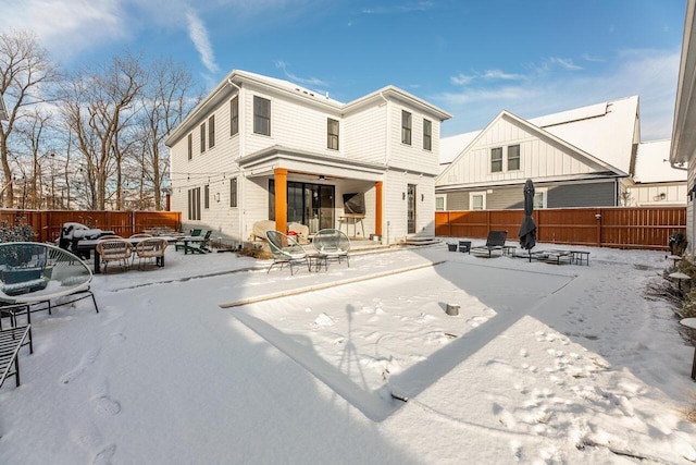 snow covered house with a fire pit