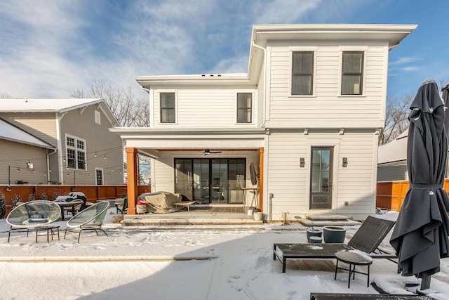 snow covered house featuring an outdoor fire pit