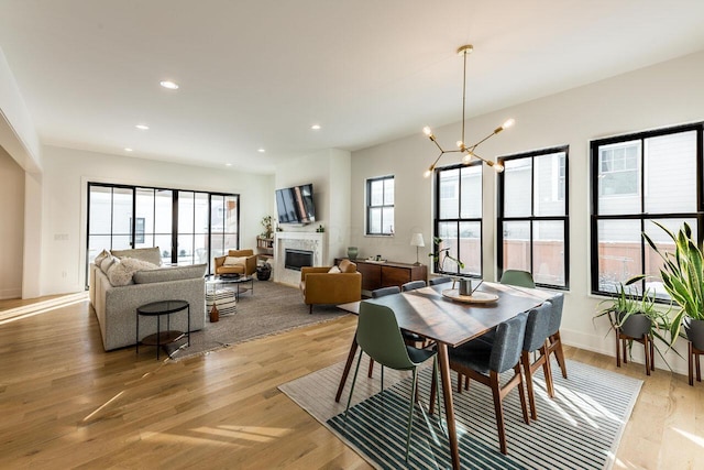 dining space with an inviting chandelier and light wood-type flooring