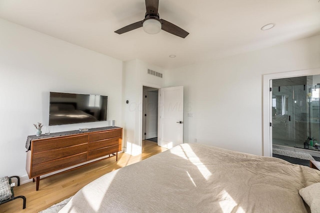 bedroom with ceiling fan, ensuite bathroom, and light hardwood / wood-style floors